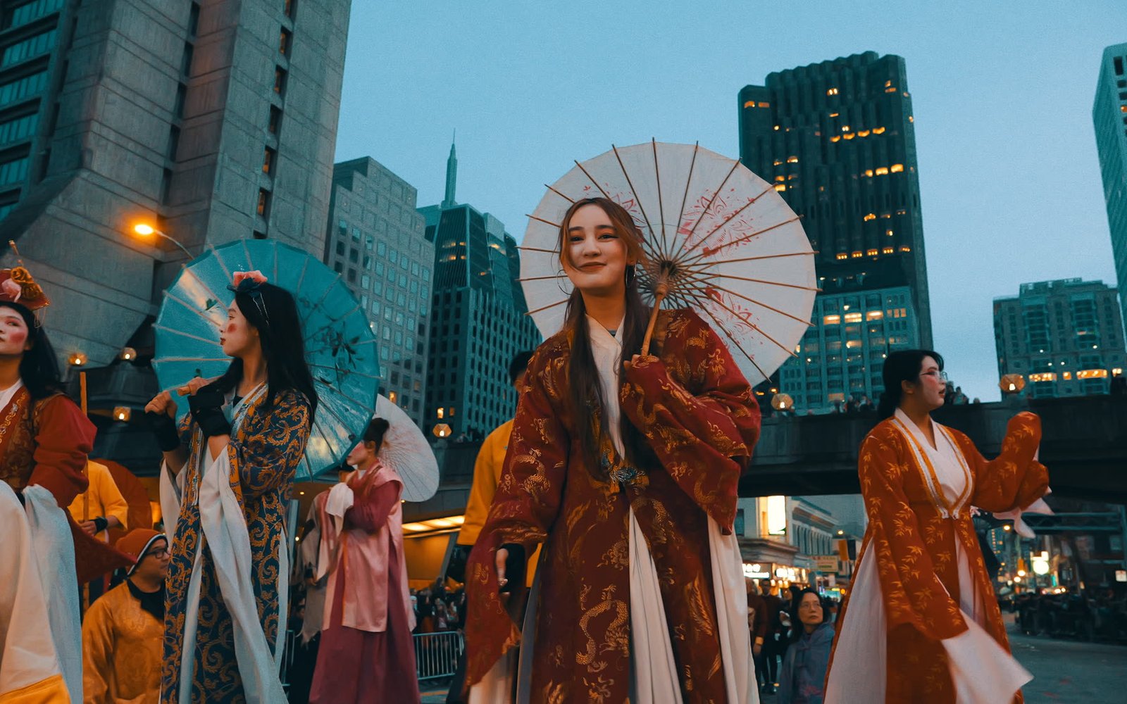 Performers in traditional dress during an evening parade in downtown San Francisco