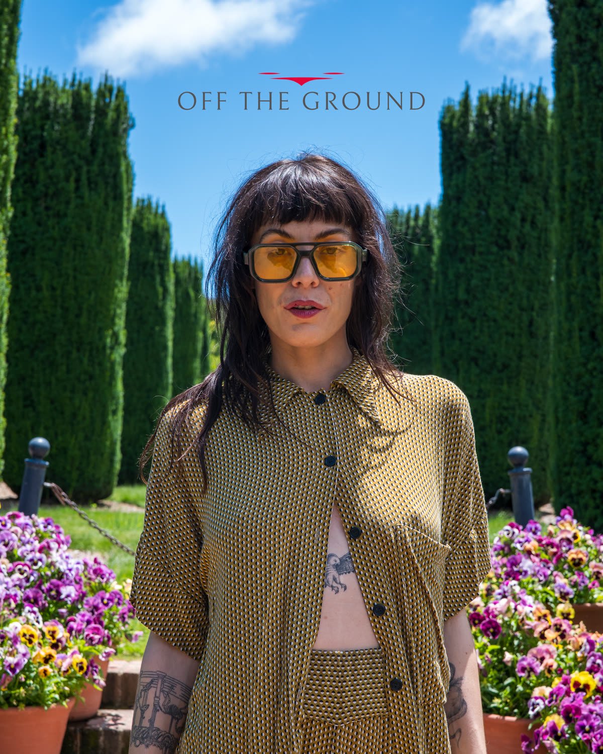 Editorial portrait in a cypress garden, styled in olive